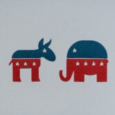 Symbols of Democrat and Republican parties cut out of paper.