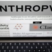 Anthropic's and Claude's black-and-white logos on a laptop screen.
