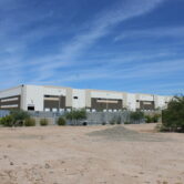 Large warehouse complex in desert landscape