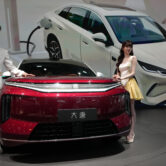 Red BYD electric sedan displayed at auto show