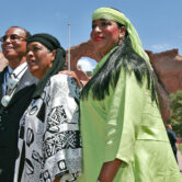 Louis Farrakhan, Khadijah Farrakhan and Maria Farrakhan Mohammad pose for photographers in front of the Window Rock Navajo Monument