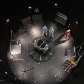 NASA technicians inspect satellite