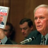 Senator holds healthcare book during congressional hearing