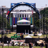 UFC cage construction on National Mall with White House behind