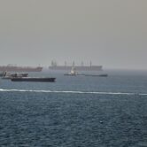 Cargo ships and tankers travel through the Gulf of Oman along major shipping routes.