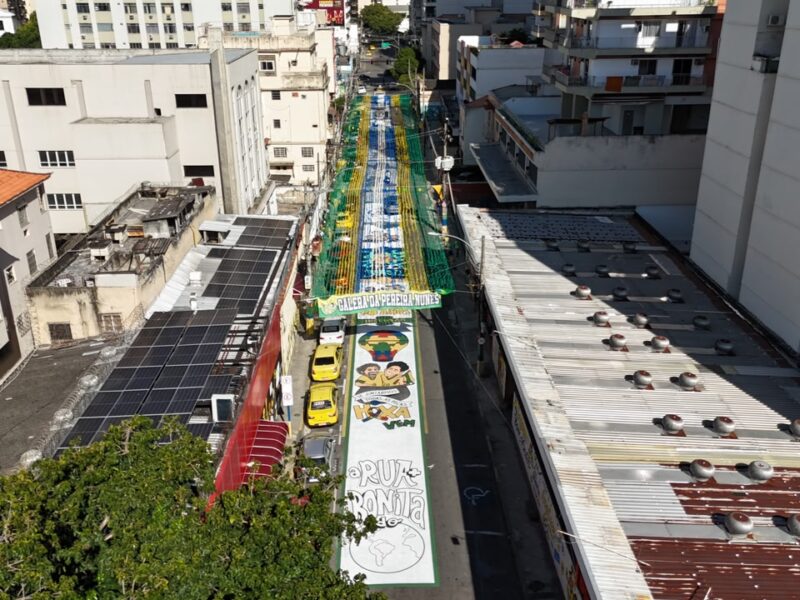 Aerial view of Pereira Nunes Street in Rio de Janeiro, covered with World Cup paintings, green-and-yellow streamers and Portuguese phrases including 