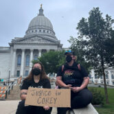 Two women hold protest sign